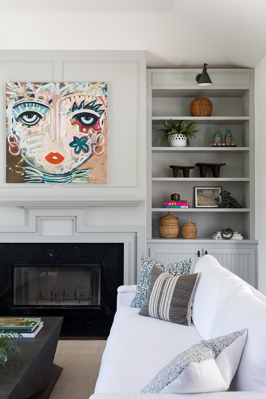 Fireplace with bold painting over it